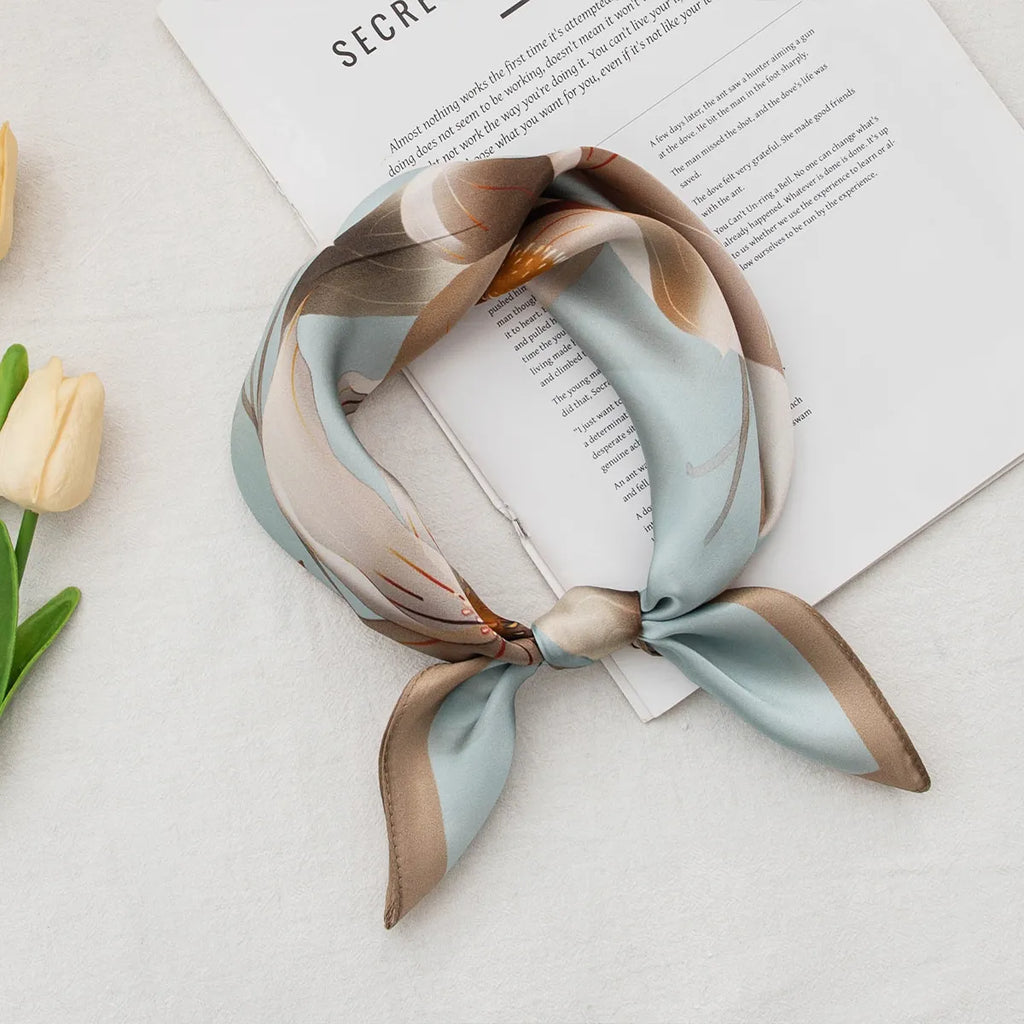 Knotted light blue silk scarf with beige magnolia pattern
