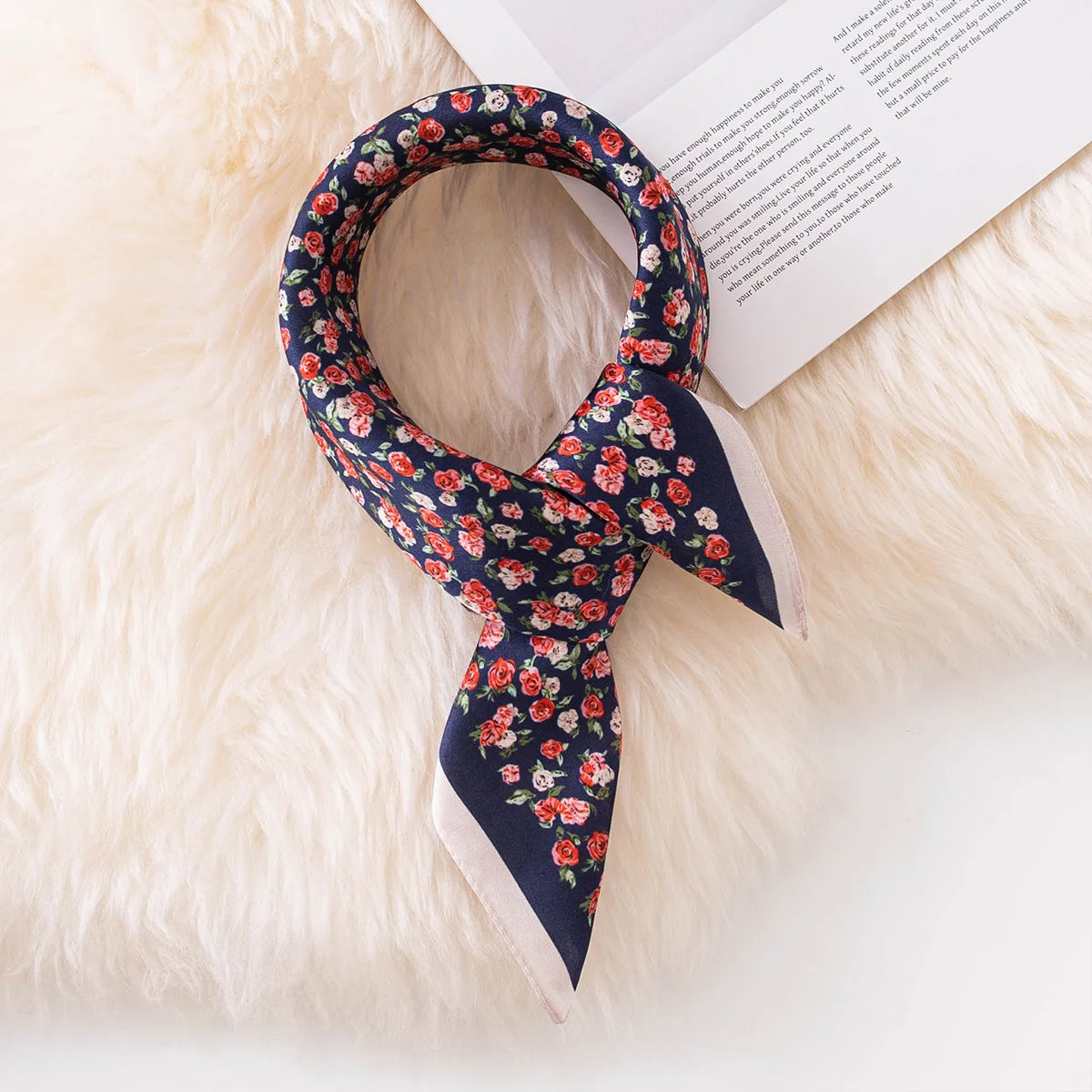 Knotted navy floral Silk Square Scarf on book