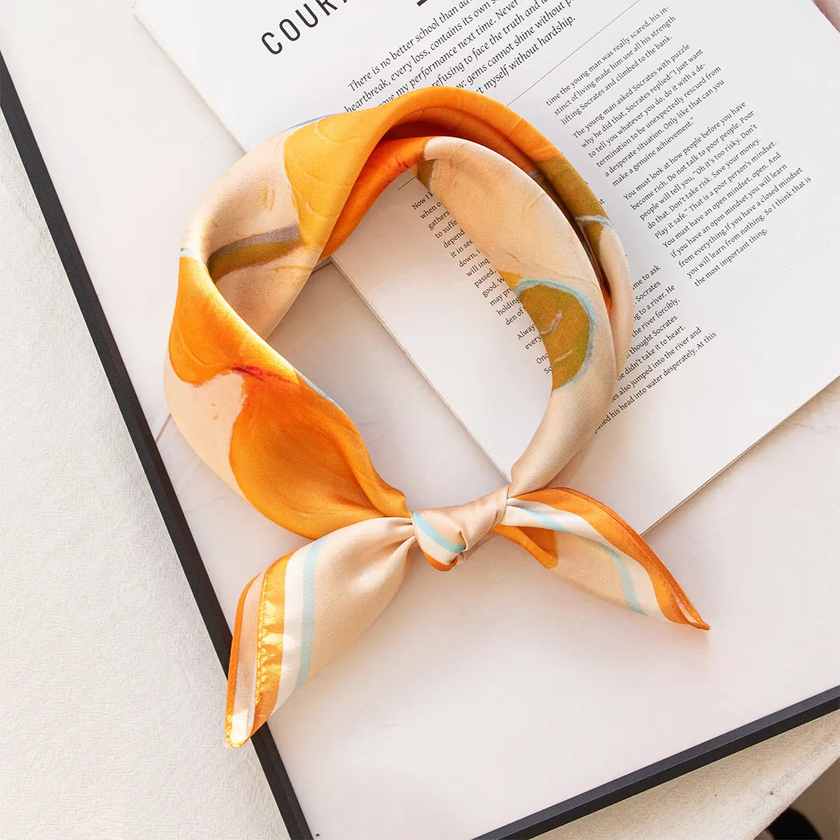 Knotted peach silk scarf with orange abstract pattern