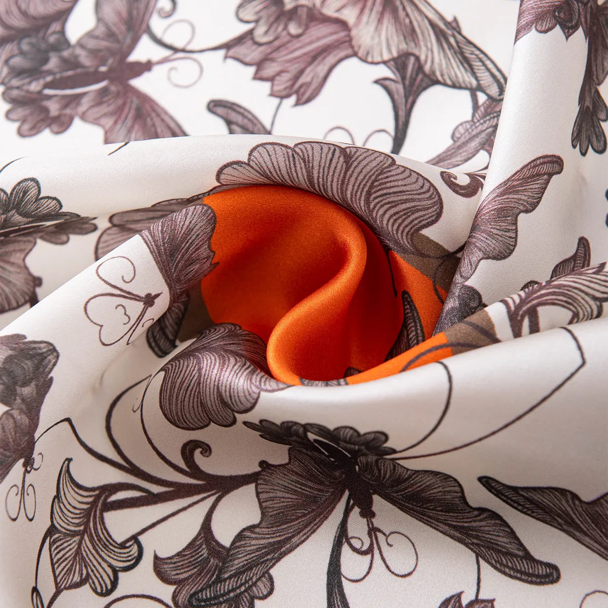 Knotted silk scarf showing orange inner side