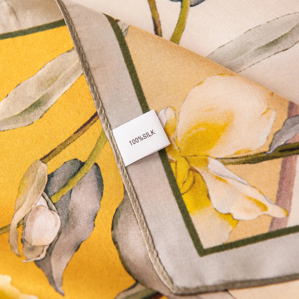 Label detail on cream yellow floral silk scarf