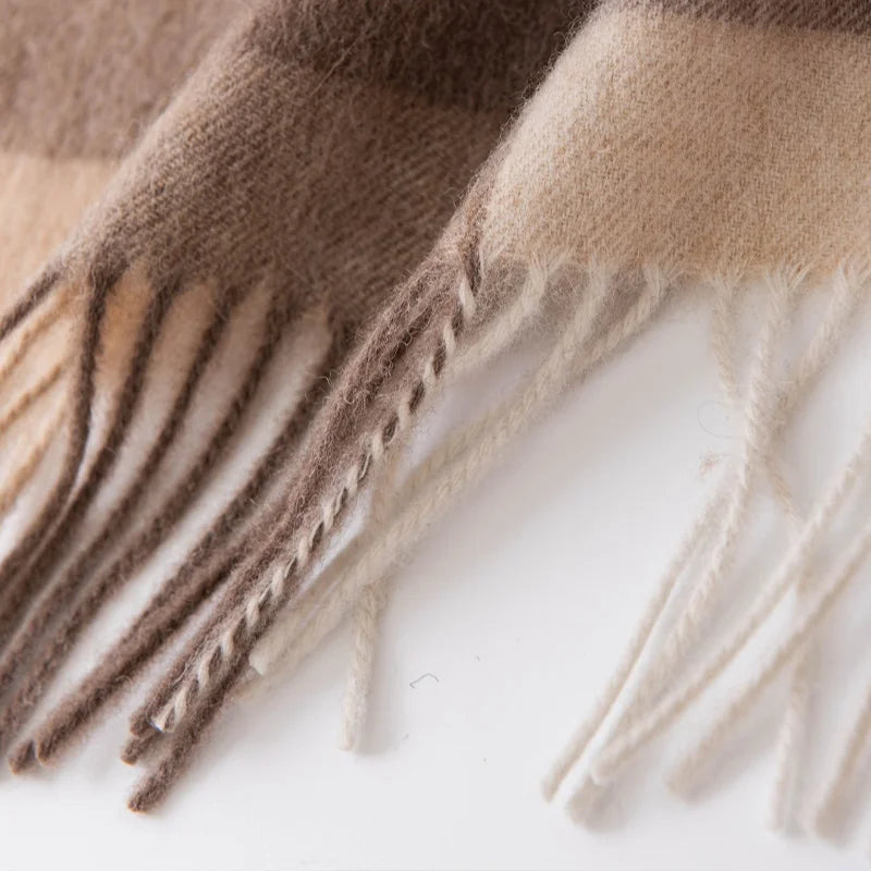 Long cream and gray fringe beneath neutral checked fabric