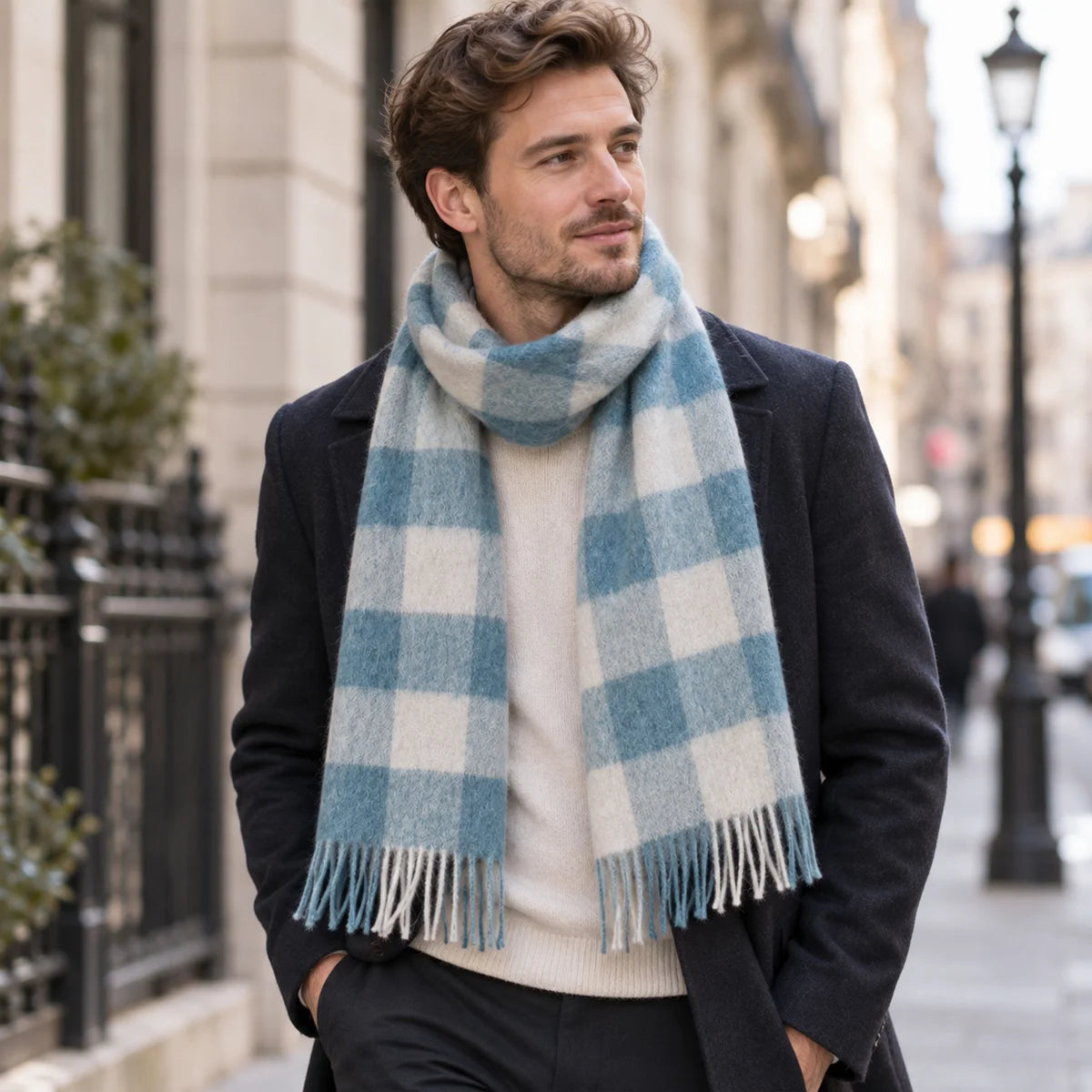 Man wearing blue cream checked wool scarf with dark coat