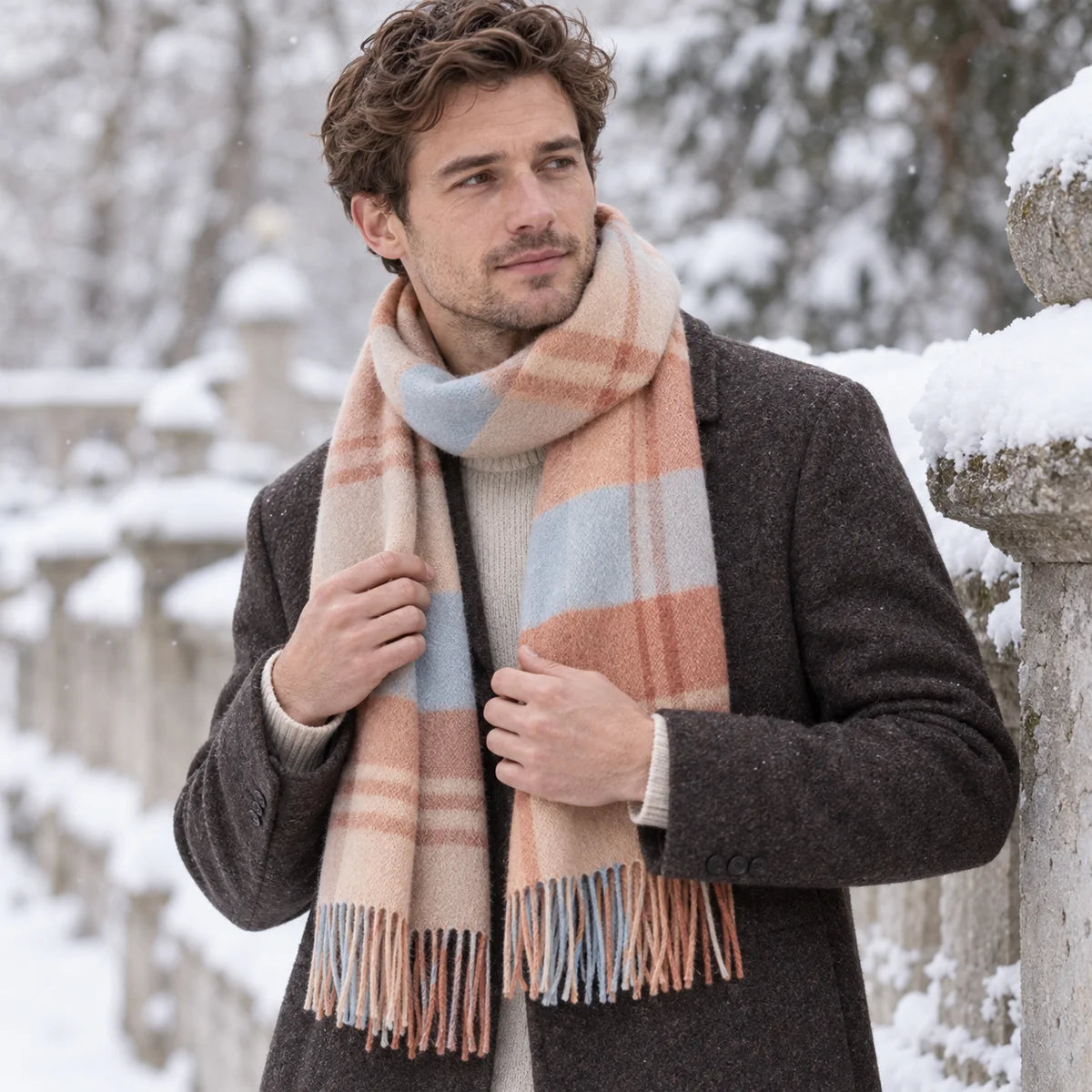 Man wearing peach blue checked wool scarf in snowy park