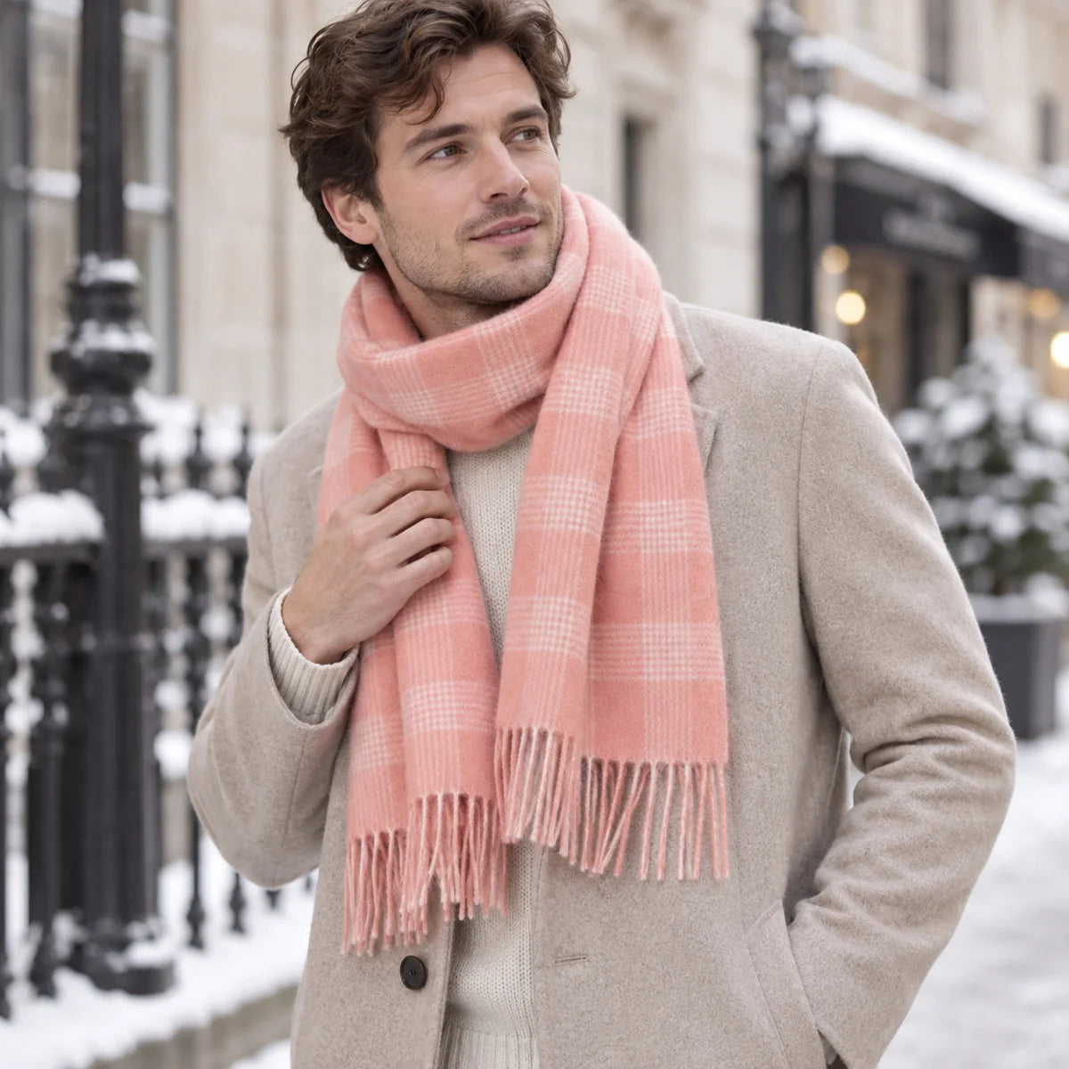 Man wearing pink plaid wool wool scarf with beige coat