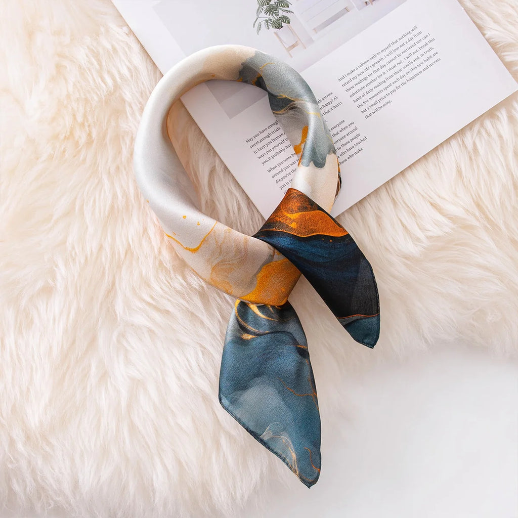 Marbled silk scarf tied flat lay