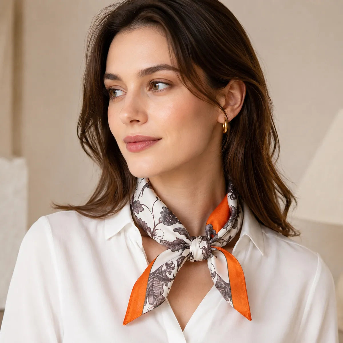 Model wearing knotted silk scarf with a white shirt
