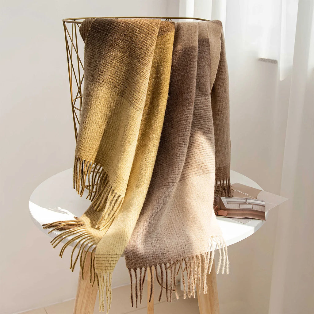 Mustard and beige checked wool scarves draped over display stand
