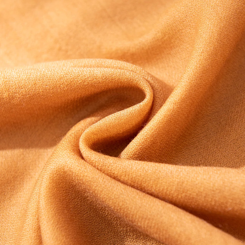 Mustard woven fabric gathered into a loose flowing fold