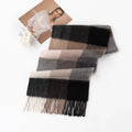 Neutral block check scarf folded beside a printed portrait