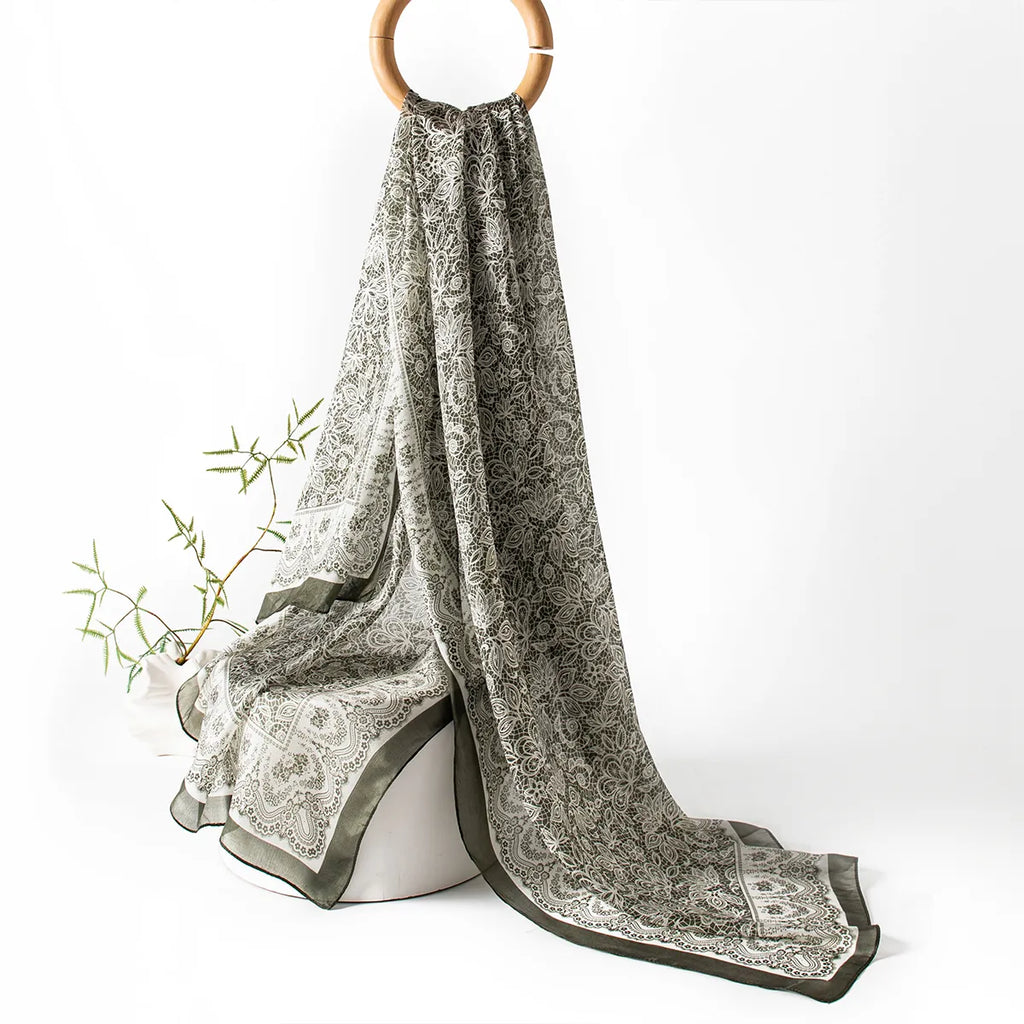 Olive botanical lace silk scarf hanging display