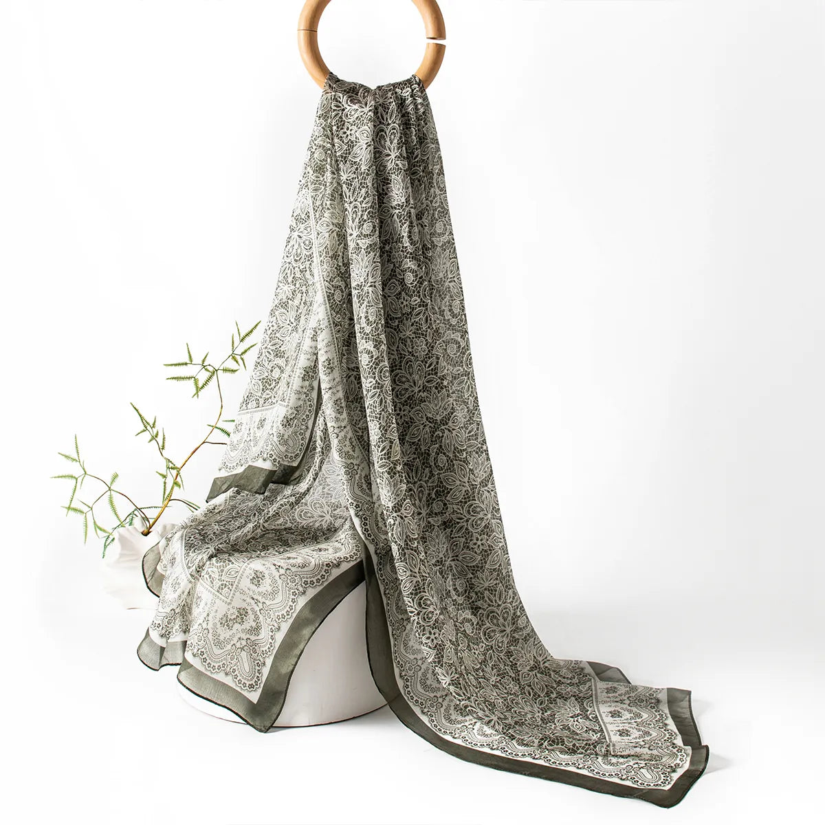 Olive botanical lace silk scarf hanging display