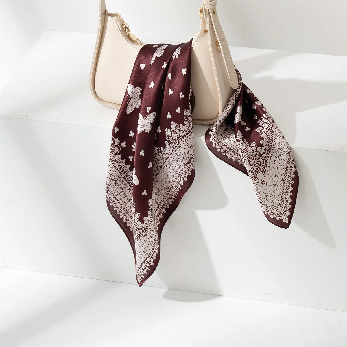 Ornamental border detail on brown butterfly silk scarf