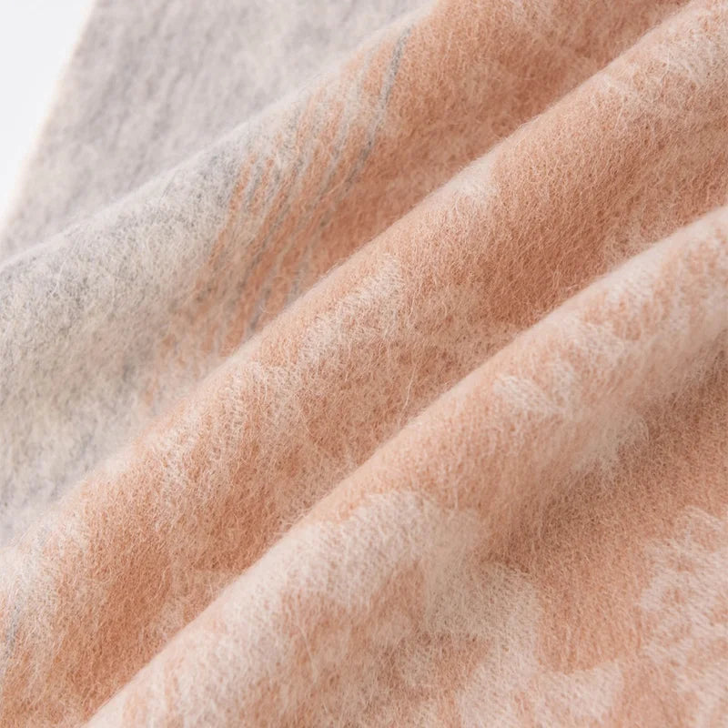 Pale floral motifs visible across peach and gray folds