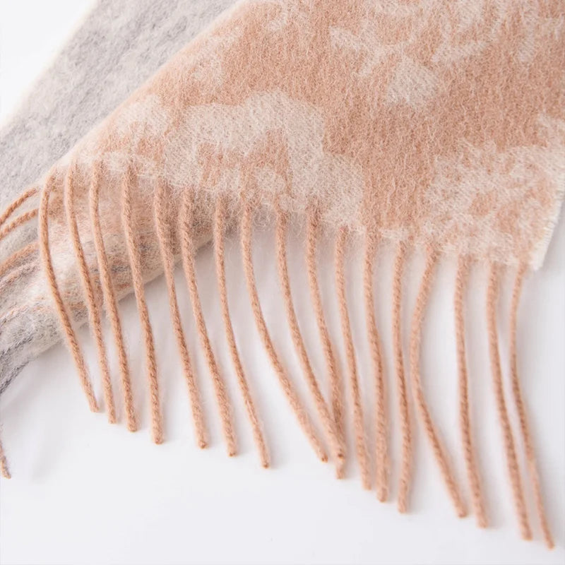 Peach twisted fringe beneath pale floral woven motifs