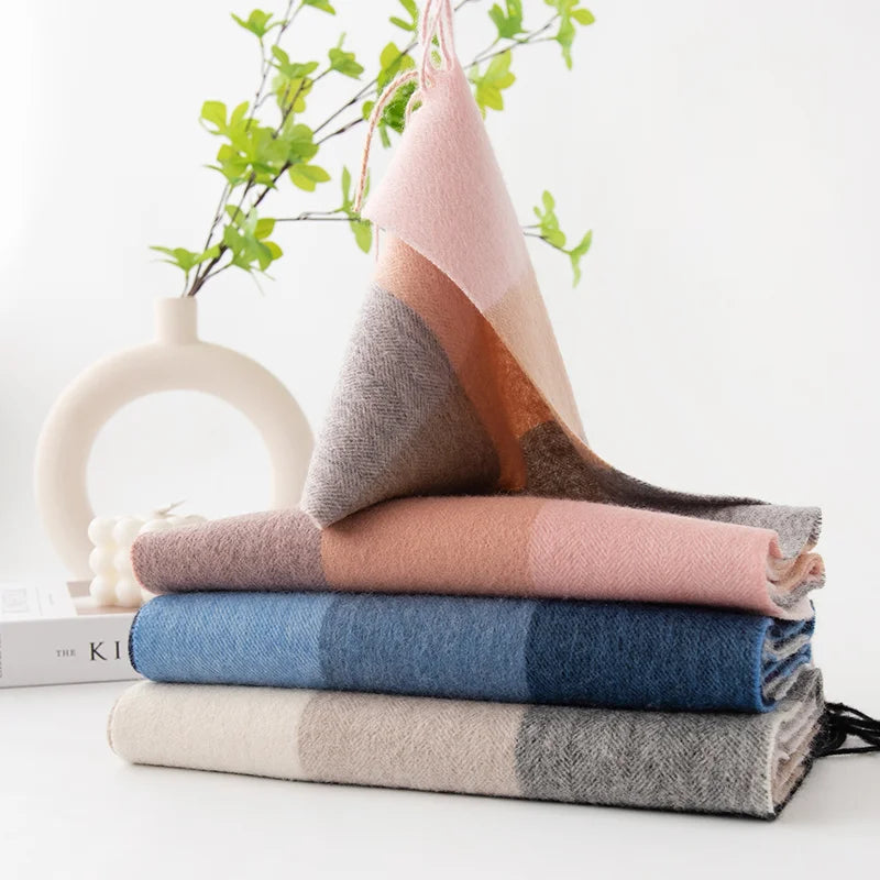 Pink blue and neutral checked scarves stacked beside vase