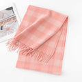 Pink cream microcheck wool scarf folded beside a printed magazine