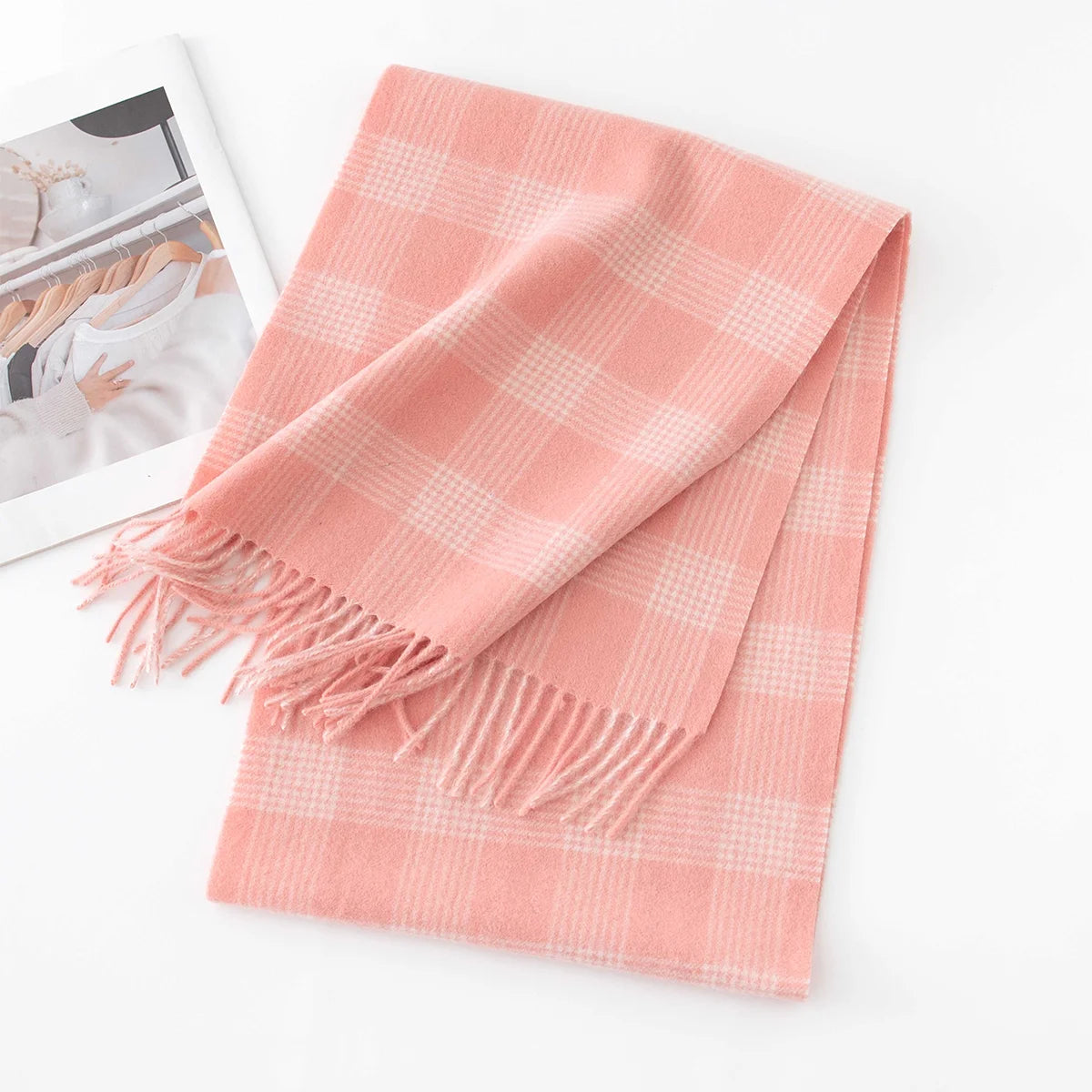 Pink cream microcheck wool scarf folded beside a printed magazine