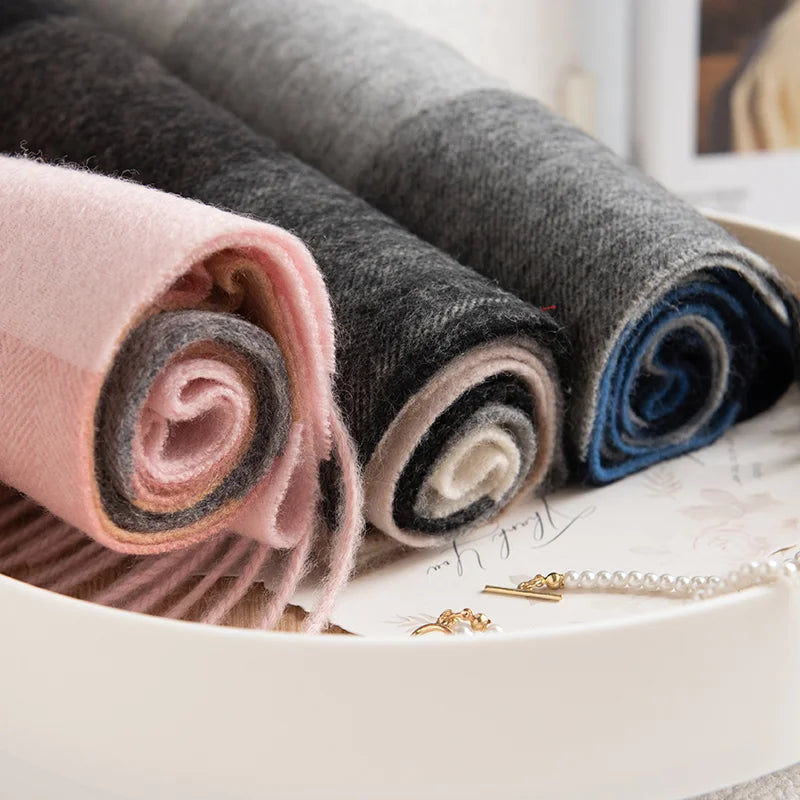 Pink gray and blue scarves rolled inside white tray