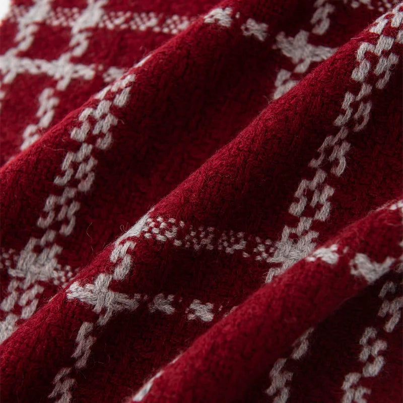 Raised cream chainlike lines crossing textured red fabric folds