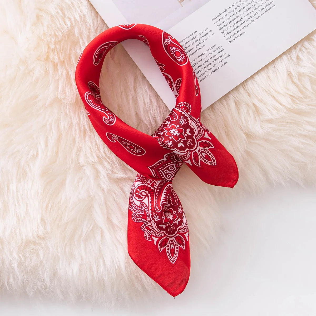 Red paisley silk scarf tied flat lay
