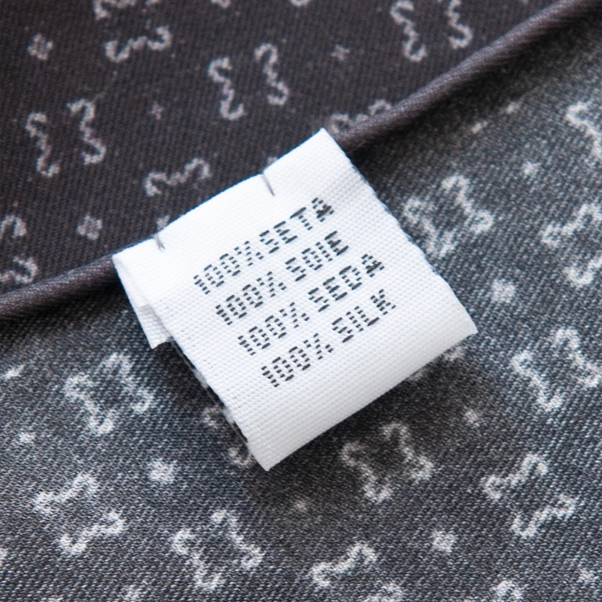 Silk Square Scarf care label with black pattern