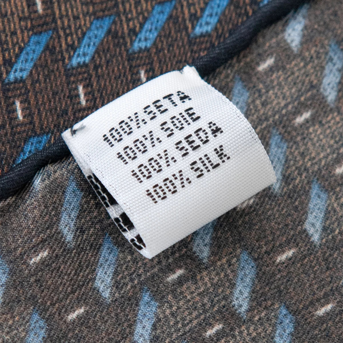 Silk Square Scarf care label with blue stripe detail
