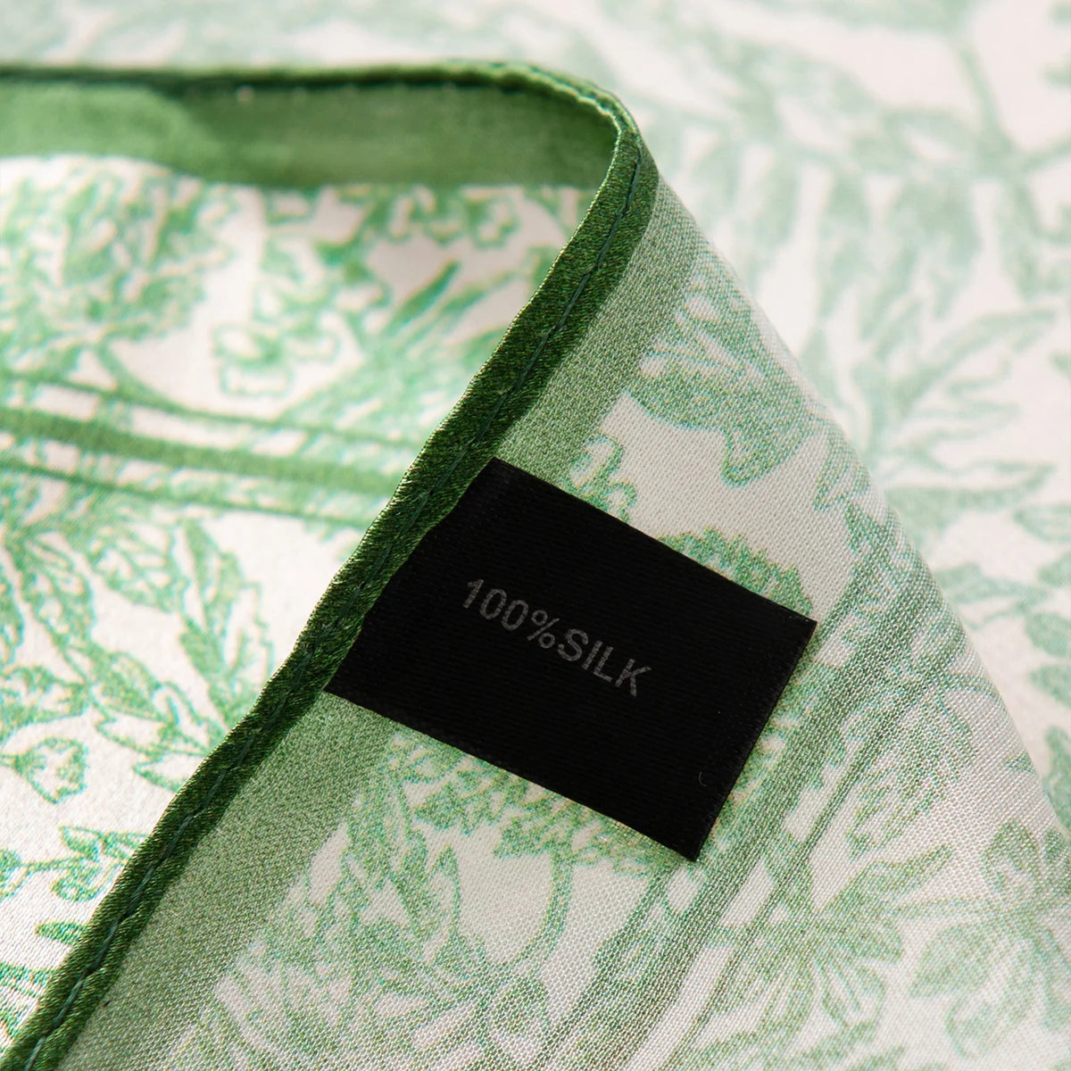 Silk Square Scarf label on green botanical fabric