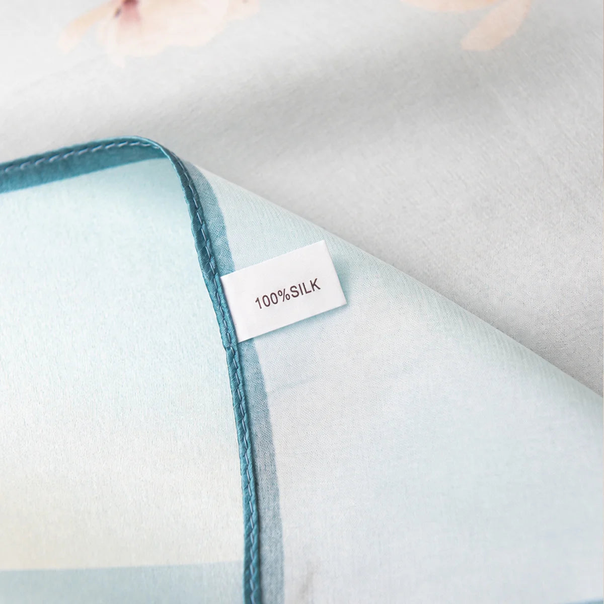 Silk Square Scarf label on light blue fabric