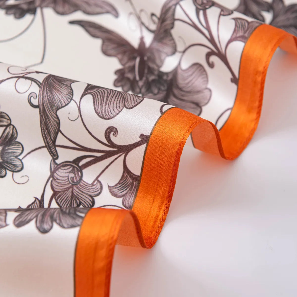 Silk folds with glossy texture and orange border