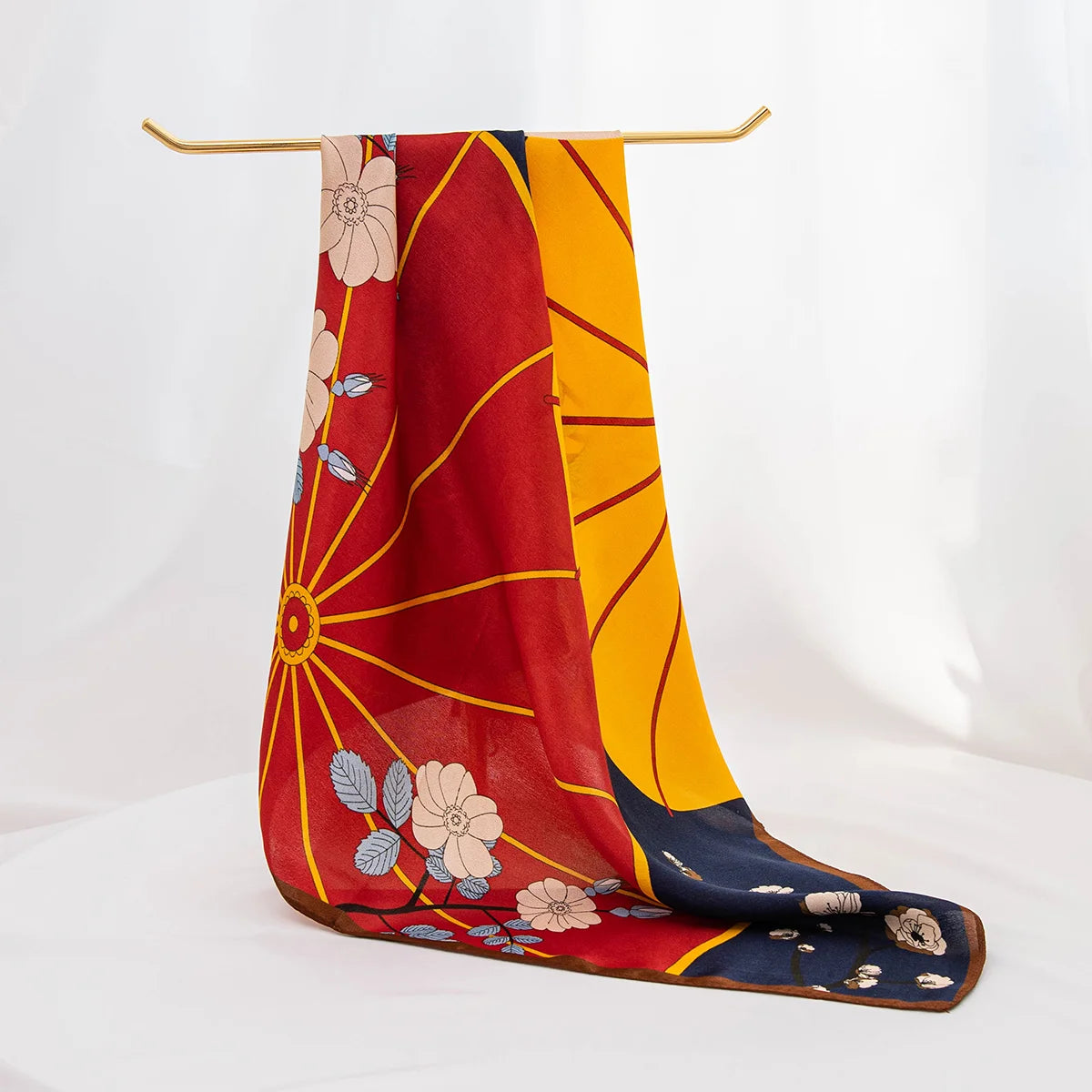 Silk scarf draped over wooden hanger