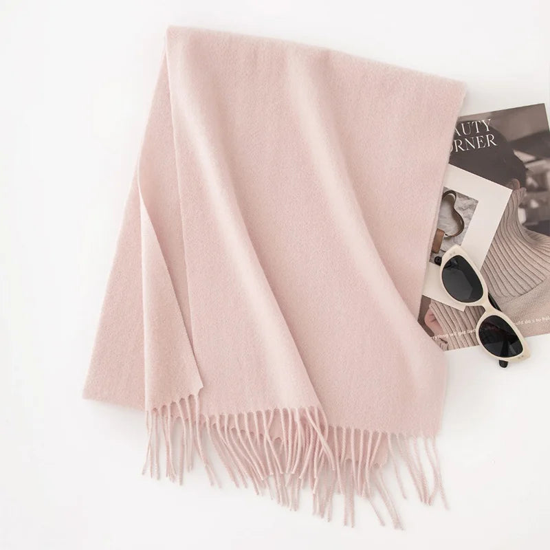 Soft blush pink fringed scarf on white background