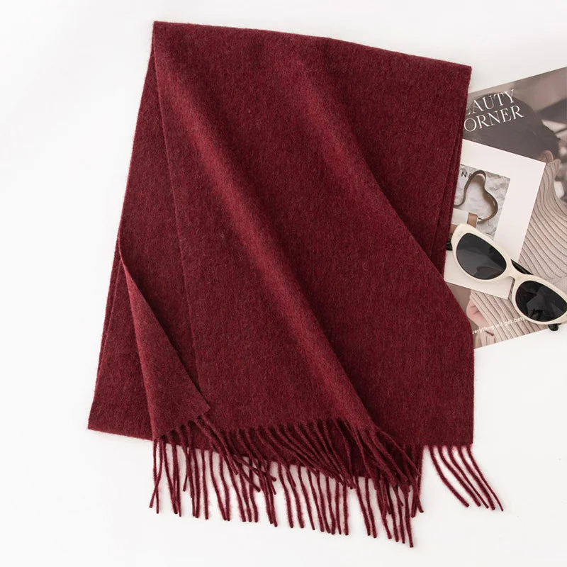 Solid burgundy fringed scarf on white background