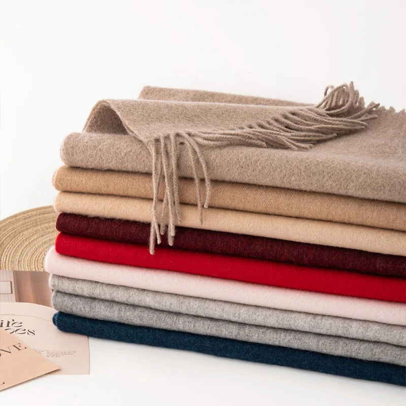 Stacked cashmere scarves showing neutral red and blue shades