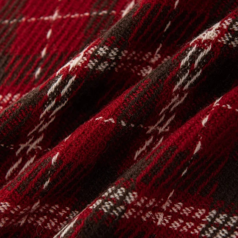 Textured red and dark plaid crossed by cream lines