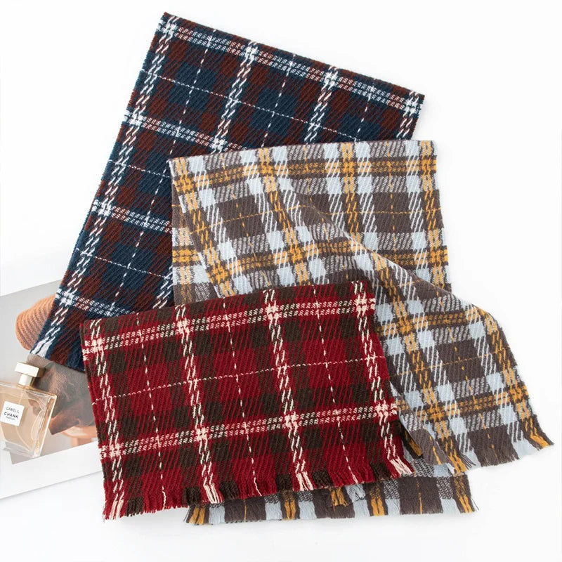 Three plaid wool scarves displayed in red blue and mustard