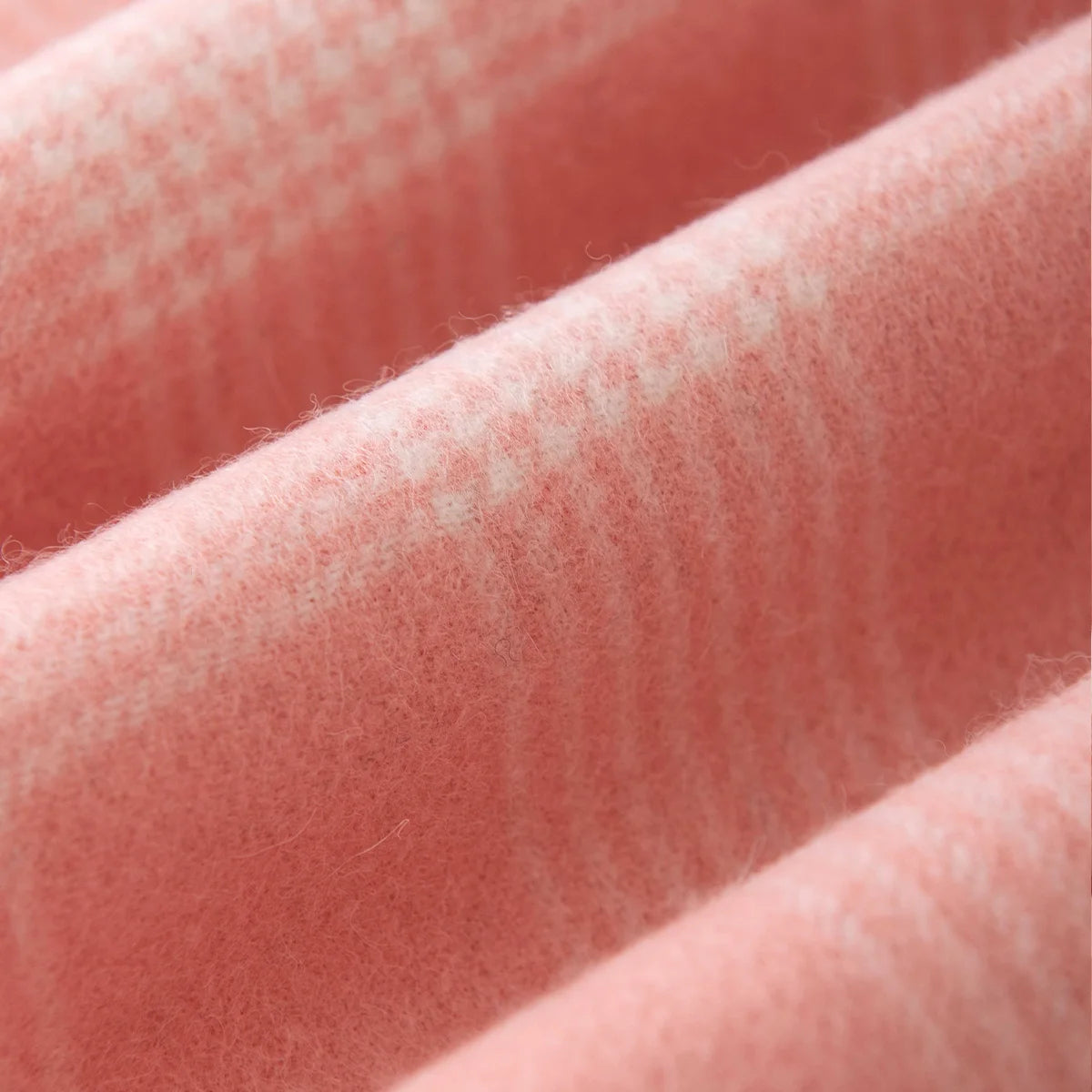 Tiny pale checks crossing softly brushed pink fabric folds