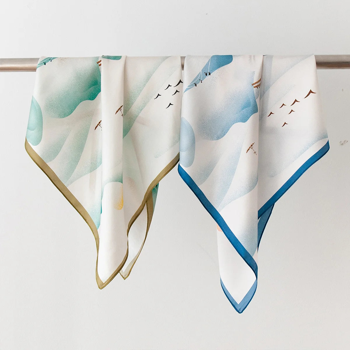 Two classical landscape Silk Square Scarves hanging display