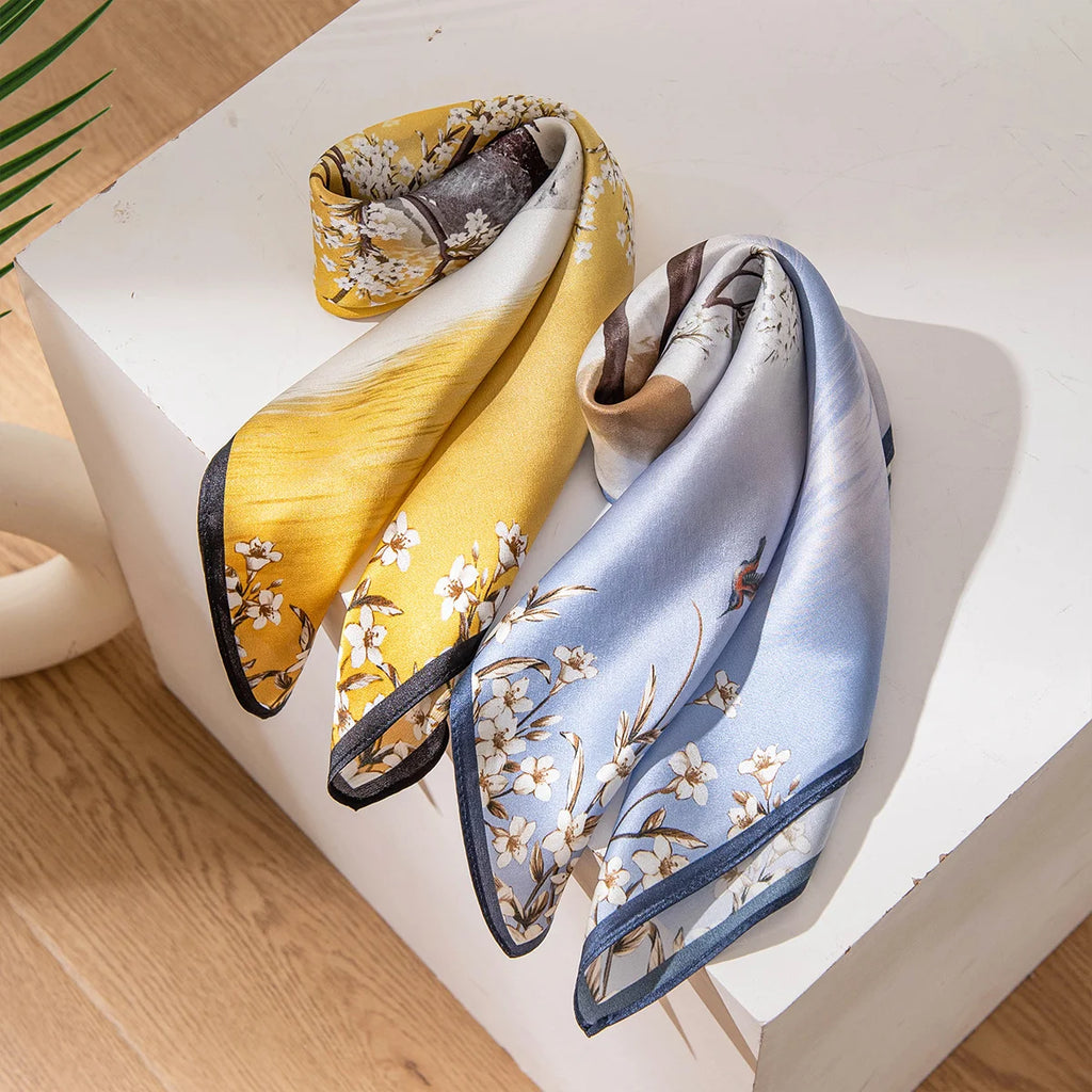 Two landscape Silk Square Scarves folded on display