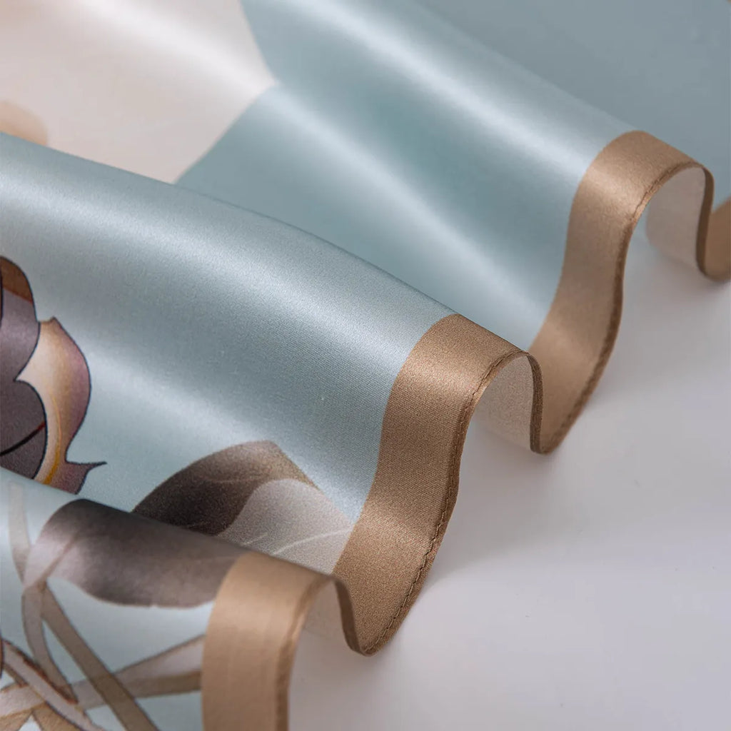 Wavy bronze rolled edge on light blue silk scarf