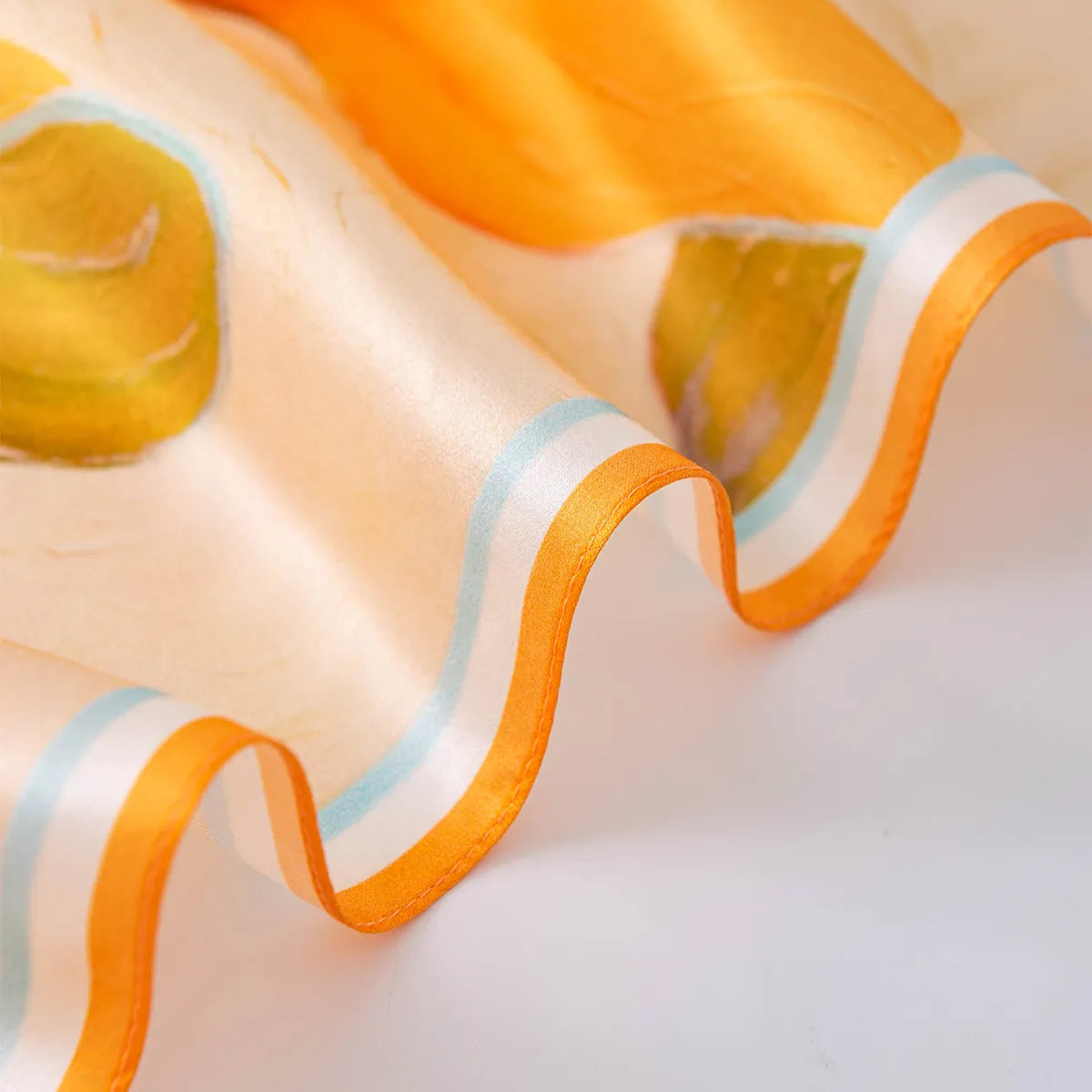 Wavy orange border on peach abstract silk scarf