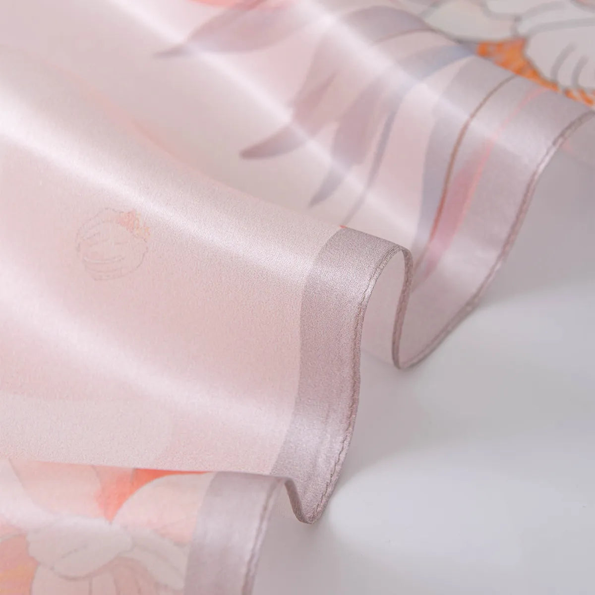 Wavy pale pink rolled edge on a light pink silk scarf
