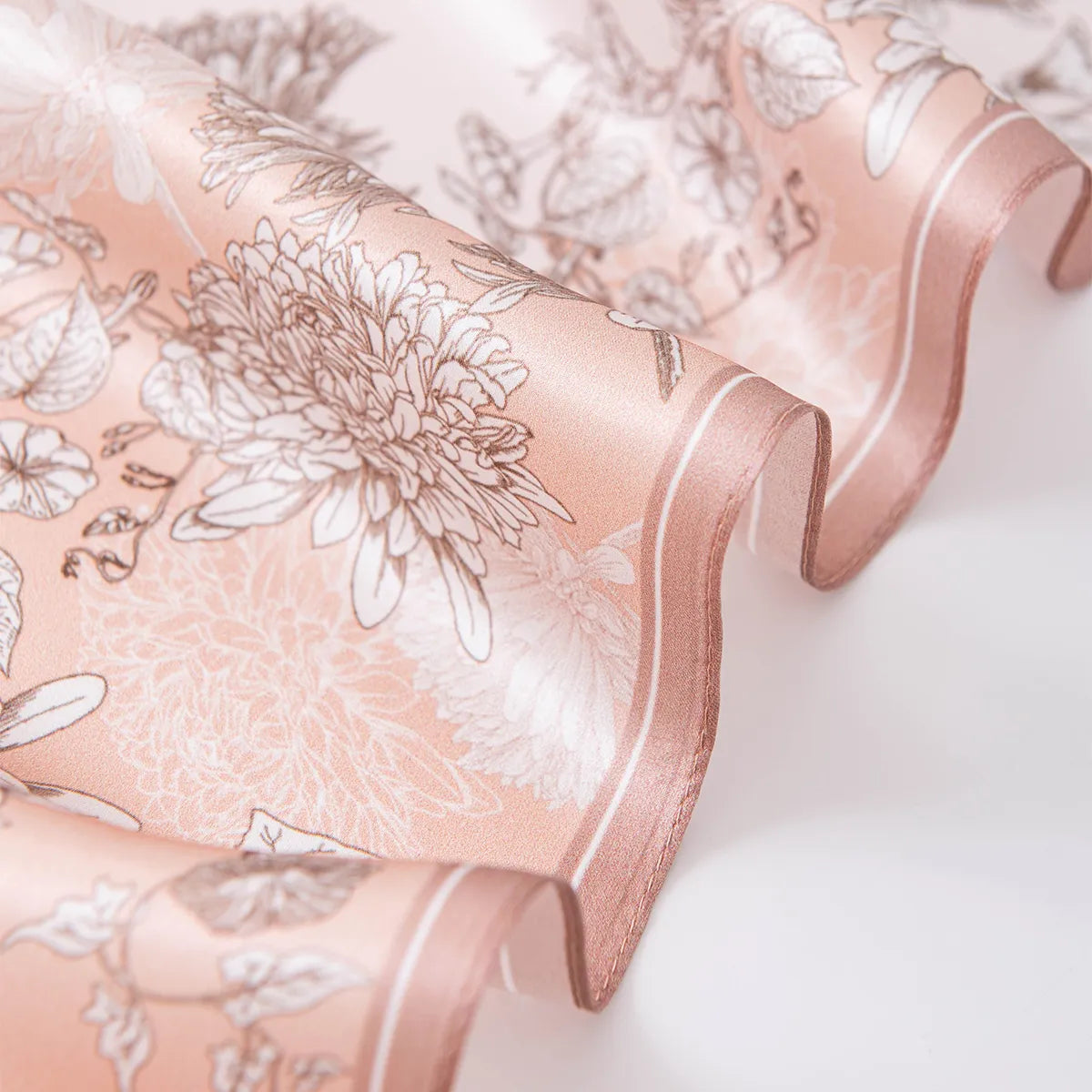 Wavy rose-gold border on pink floral silk scarf