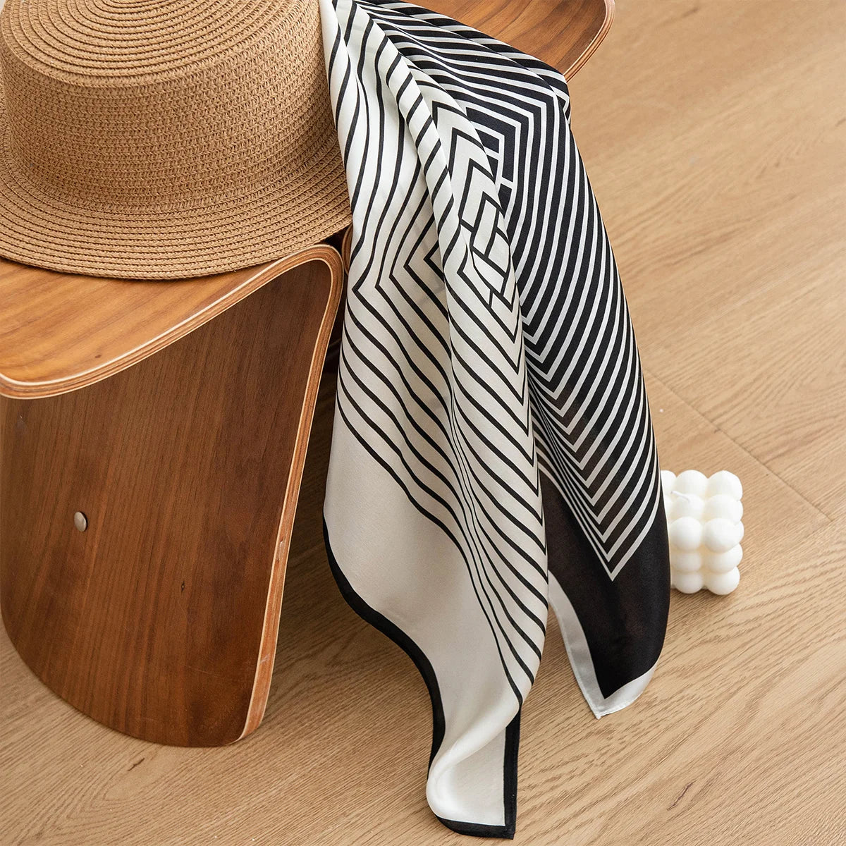 White concentric square Silk Square Scarf draped on hat
