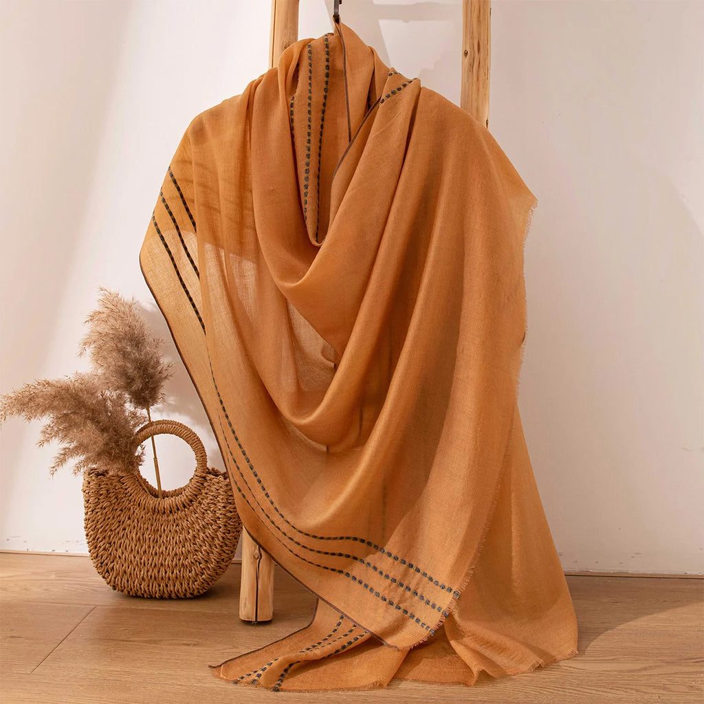 Wide mustard wrap cascading beside a basket of grasses