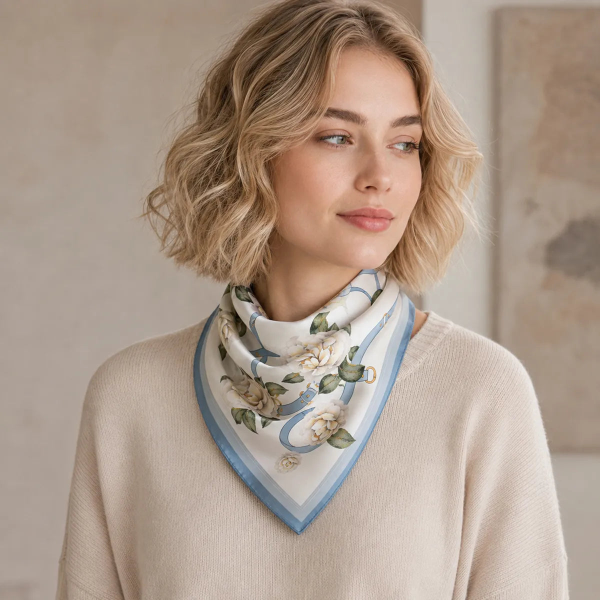 Woman wearing blue and white floral silk scarf in triangle style