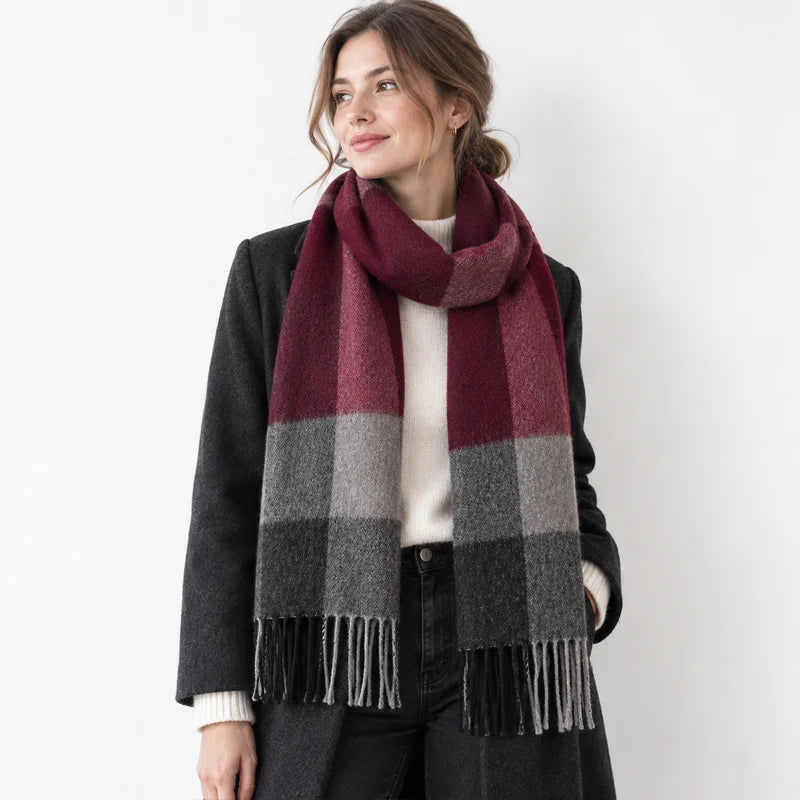 Woman wearing burgundy gray striped wool scarf over black coat