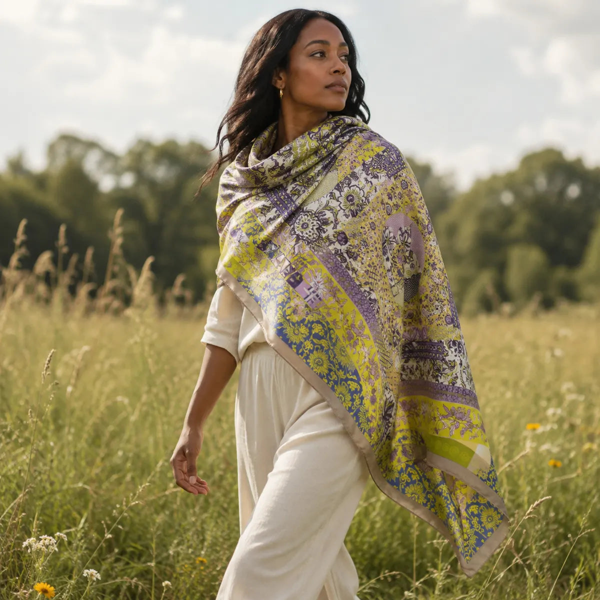 Woman wearing citron paisley silk shawl in meadow