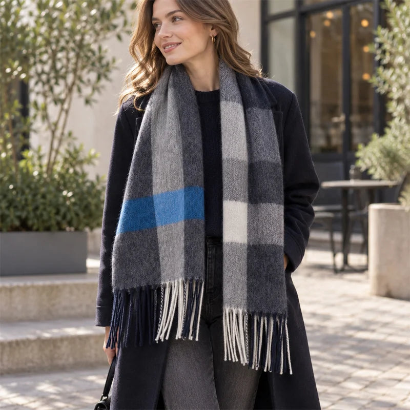 Woman wearing gray blue striped scarf with black coat