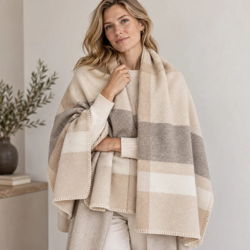 Woman wearing oversized checked cashmere wrap across her shoulders